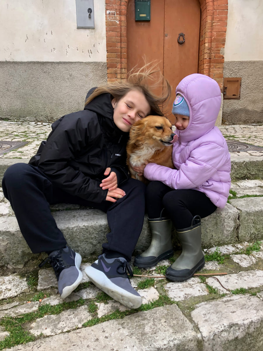 Family members embracing a rescued dog.